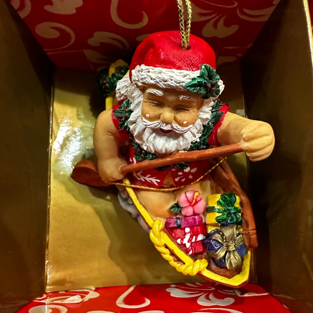 Hawaiian designer Christmas ornament- santa in a canoe!